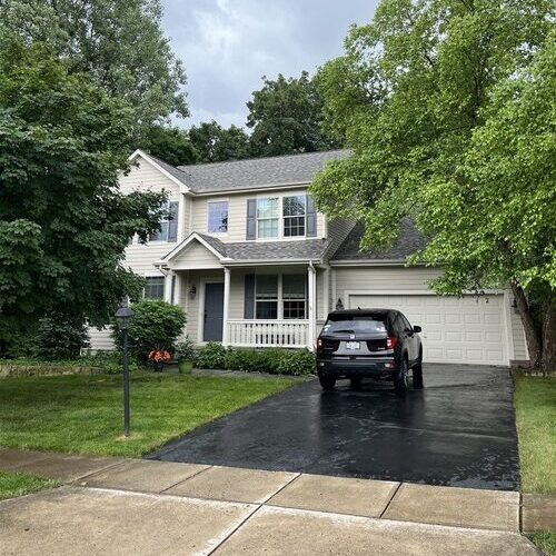 a suburban home with a shingle roof