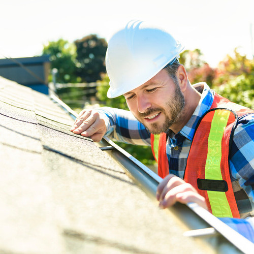 a roofer inspecting a roof